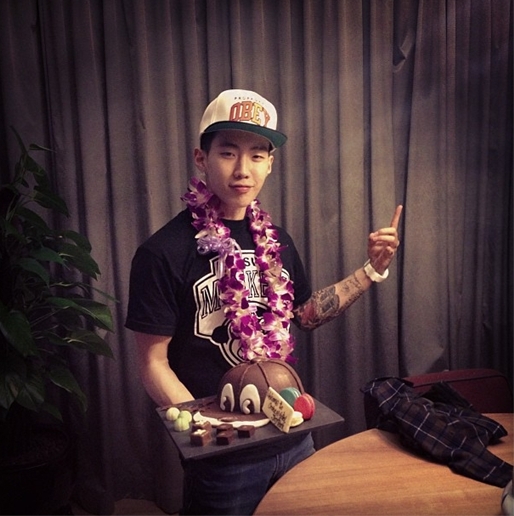 Jay Park poses for the camera with a cap-like cake