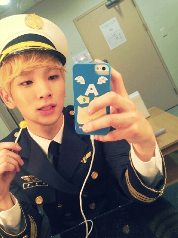 SHINee’s Key in a pilot uniform with a lollipop