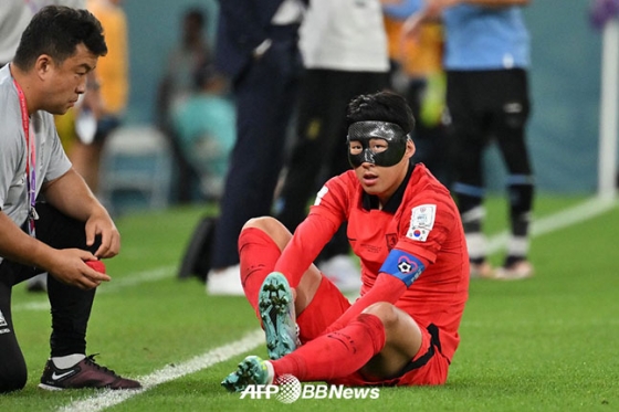 상대 태클에 걸려 넘어진 뒤 벗겨진 축구화를 다시 신고 있는 손흥민. /AFPBBNews=뉴스1