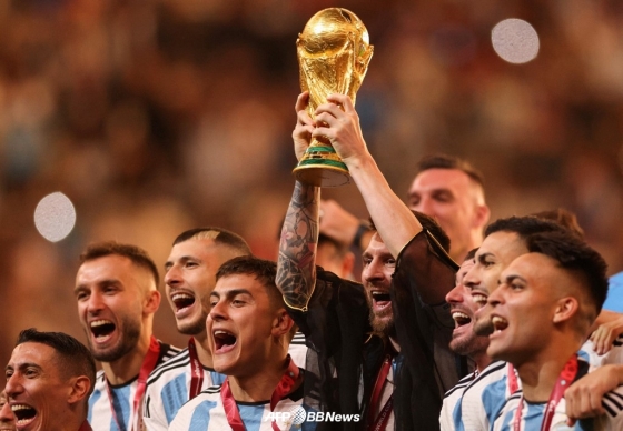 메시(가운데)가 19일(한국시간) 2022 카타르 월드컵 우승 시상식에서 트로피를 들어올리며 동료들과 함께 기뻐하고 있다. /AFPBBNews=뉴스1