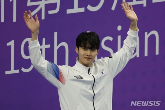 시상대에 오르며 두 팔을 들고 관중들에게 인사하는 황선우. /사진=뉴시스