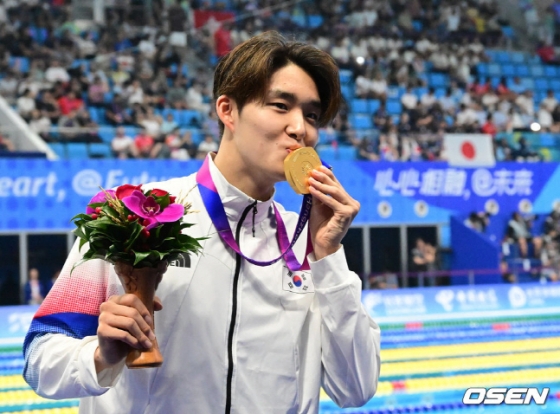 28일 자유형 800m에서 우승 후 금메달에 입을 맞추고 있는 김우민. /사진=뉴시스