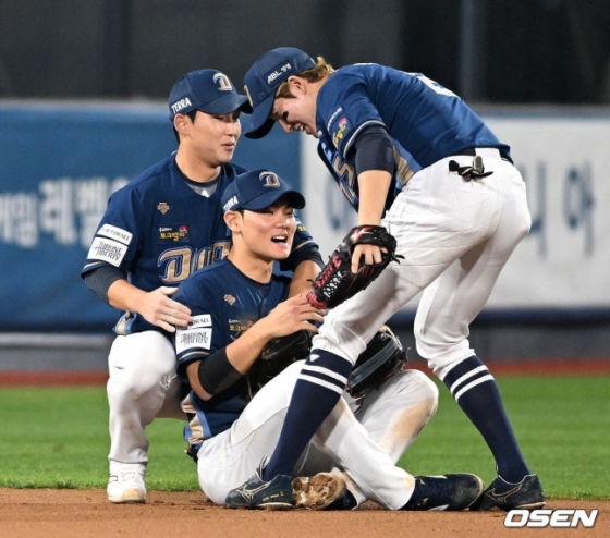 NC 김주원(가운데)이 지난달 31일 수원 케이티 위즈 파크에서 열린 2023 KBO 플레이오프 2차전에서 9회 말 오윤석의 타구를 몸을 날려 잡아내자 3루수 서호철(왼쪽)과 2루수 박민우가 다가와 기쁨을 나누고 있다.