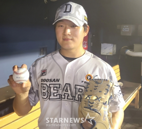 두산 베어스 신인 투수 김택연이 마무리 투수 변신 후 첫 세이브를 따내고 기념구를 들고 포즈를 취하고 있다. /사진=안호근 기자