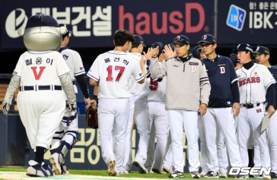 이승엽(오른쪽에서 세 번째) 감독을 비롯한 두산 코칭스태프와 선수들이 승리 후 하이파이브를 하고 있다.