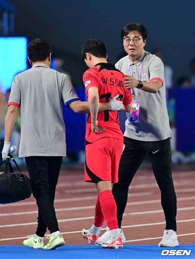 한국 대표팀 공격수 엄원상(가운데)이 2022 항저우 아시안게임 준결승에서 부상을 당해 경기장을 빠져나가고 있다. 황선홍 감독(오른쪽)이 이를 위로하고 있다. /사진=OSEN