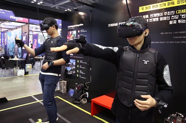 VR게임을 즐기고 있는 참관객들.