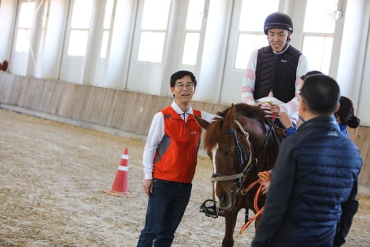 김낙순한국막사회 회장(왼쪽)이 재활승마에서 사이드워커 봉사를 하고 있다./사진제공=한국마사회
