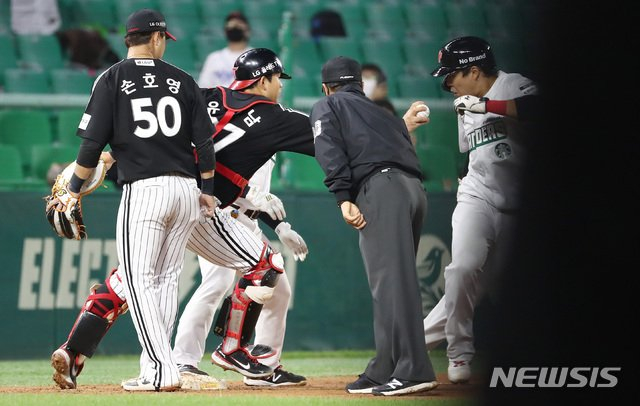 LG 포수 유강남(왼쪽에서 두 번째)이 이미 아웃이 선언된 2루 주자 한유섬(오른쪽)을 태그 아웃시키려 하고 있다. 이 상황을 지켜보고 있는 이용혁(오른쪽에서 두 번째) 3루심. /사진=뉴시스