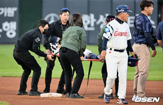 롯데 황성빈이 28일 사직 키움전에서 1회 말 도루 시도 과정에서 발목을 다치며 들것에 실려 구급차로 향하고 있다.