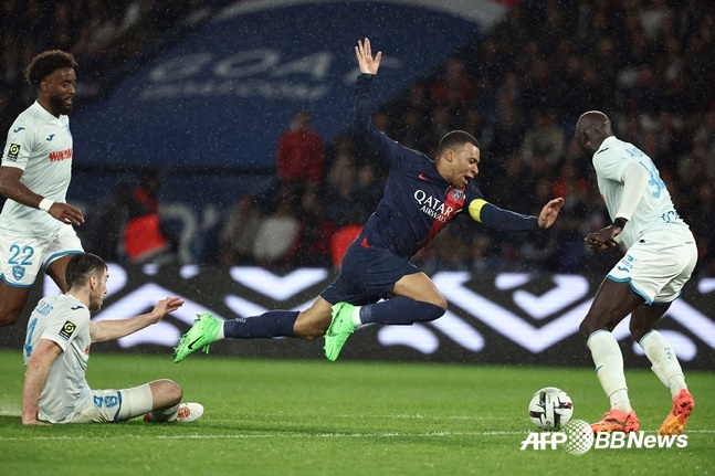 킬리안 음바페(가운데)가 28일(한국시간) 프랑스 파리의 파르크 데 프랭스에서 열린 PSG 대 르아브르와의 '2023~2024시즌 프랑스 리그1' 31라운드에서 상대 수비에 걸려 넘어지고 있다. /AFPBBNews=뉴스1