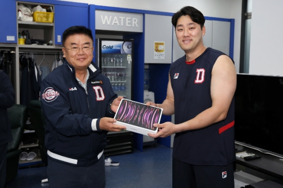 지난 11일 박정원 구단주의 지시로 김태룡 단장이 주장 양석환에게 태블릿PC를 전달하고 있다. /사진=두산 베어스 제공