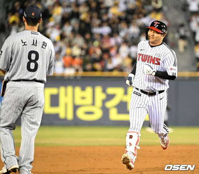 LG 문보경(오른쪽)이 26일 잠실 한화전 4회말 무사에서 중월 솔로포를 날리고 3루로 향하고 있다.